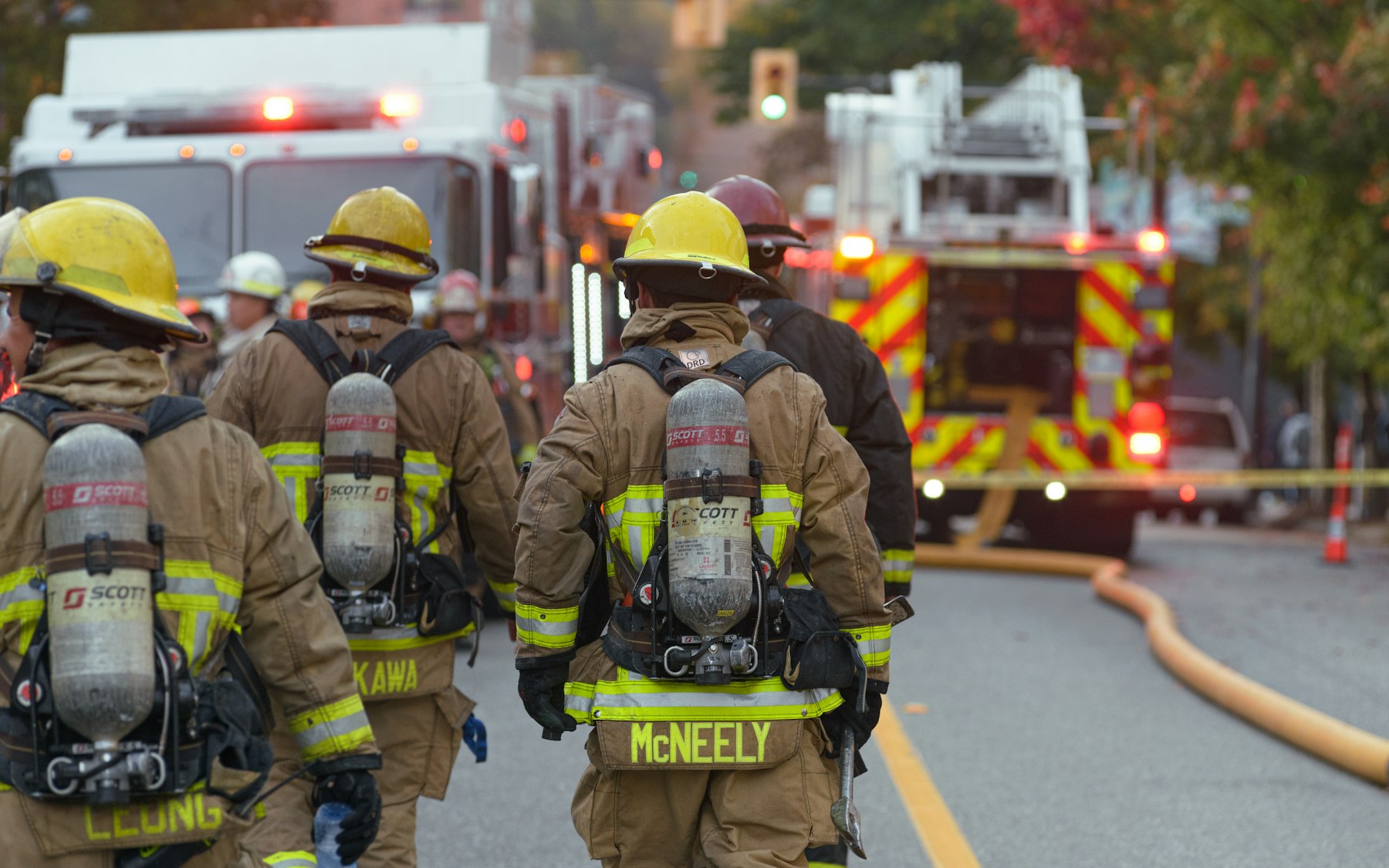 Firefighters walking toward the engines at the end of a call.