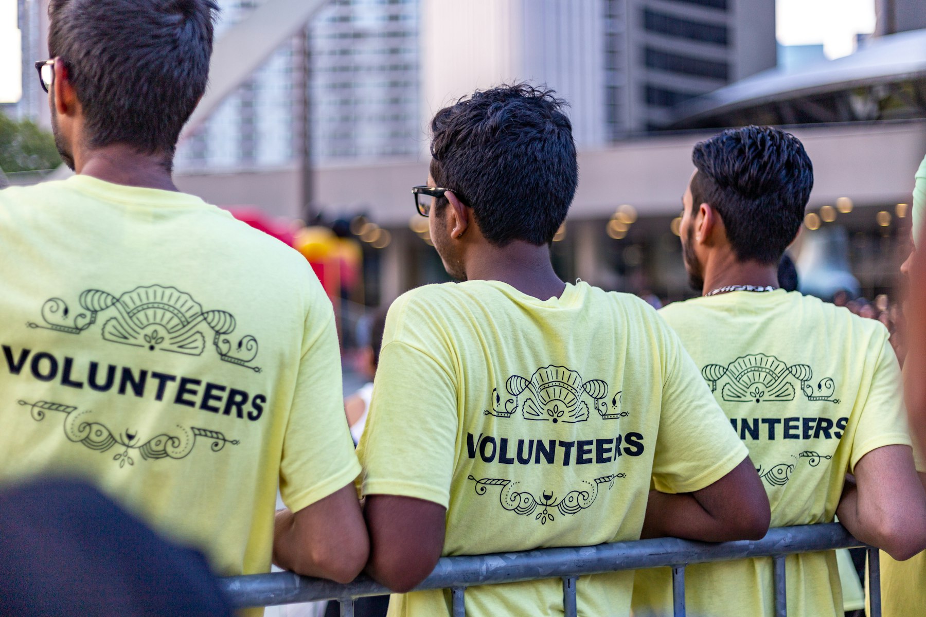 Volunteers in matching shirts working together outdoors.